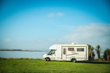 motorhome on a camping ground, caravan vacations, campervan trip - obrazy, fototapety, plakaty