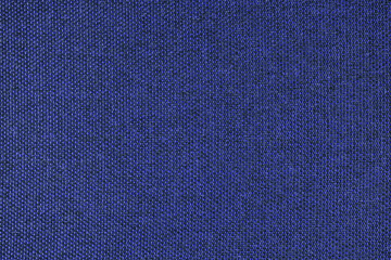 Close-up texture of natural blue coarse weave fabric or cloth. Fabric texture of natural cotton or linen textile material. Blue canvas background. Decorative fabric for upholstery, furniture, walls