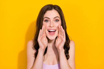 Fototapeta premium Portrait of positive person hands near open mouth say scream isolated on yellow color background