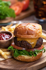 Cheeseburger with lettuce and tomato on toasted bun
