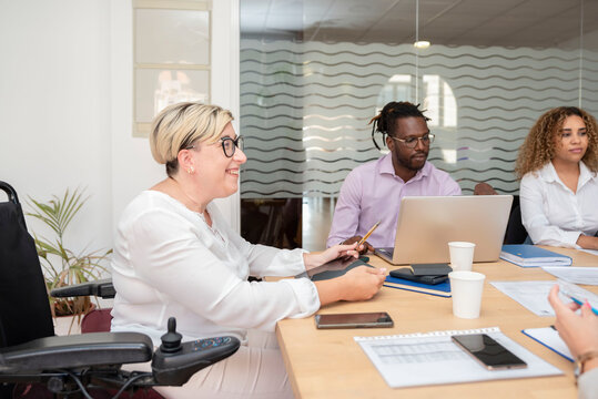 a woman leader in the wheelchair at the business meeting