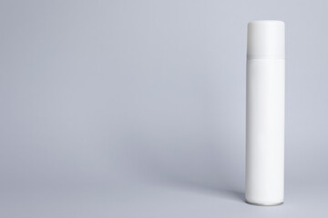 Bottle of dry shampoo on grey background, space for text