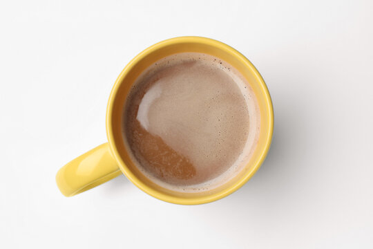 Yellow mug of freshly brewed hot coffee on white background, top view - Powered by Adobe