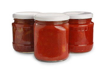 Glass jars of delicious canned lecho on white background