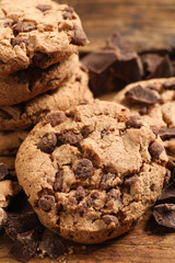 Many delicious chocolate chip cookies on wooden table, closeup