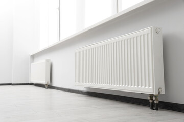 Modern radiators in room. Central heating system