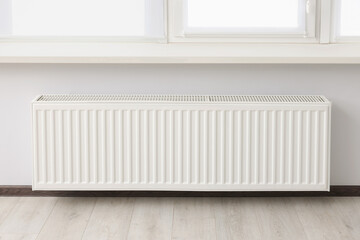 Modern radiator in room. Central heating system