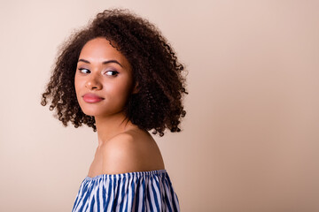 Profile portrait of pretty gorgeous person wavy hairdo look empty space isolated on beige color background © deagreez