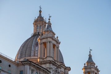 Fototapeta na wymiar Impressive view of church tower in Rome with blue sky in background.