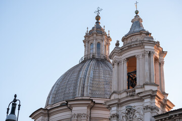 Fototapeta na wymiar Impressive view of church towers in Rome with blue sky in background. Chiesa di Sant 'Agnese.