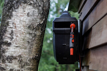 Garden watering reel with a water hose on the wall