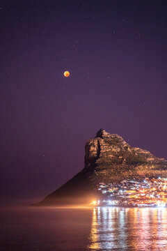 View of Super Flower Blood Moon lunar eclipse of 16 May 2022 from Hout Bay, Cape Town, Western Cape, South Africa.