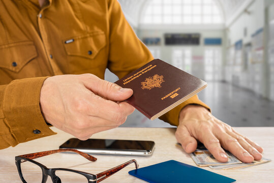 Traveling Businessman Handing His International Passport For Customs Control, Inscription European Union French Republic Passport