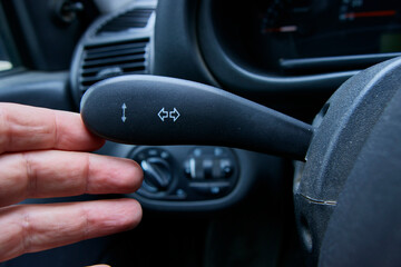 the turn signal lever, the driver turns on the turn signal