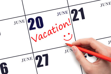 A hand writing a VACATION text and drawing a smiling face on a calendar date 20 June. Vacation...