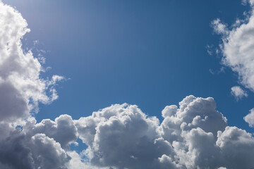 Naklejka na ściany i meble Beautiful blue sky with bright cumulus clouds