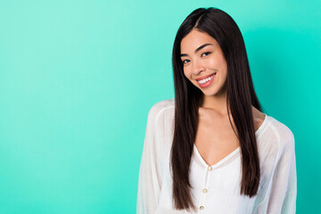 Portrait of cheerful friendly young girl toothy beaming smile empty space blank isolated on vibrant emerald color background