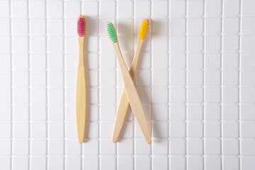 Roman numeral IX composed of toothbrushes on a white tiled background