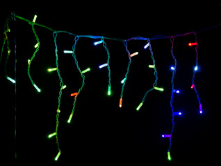 Colored Christmas garlands on a black background