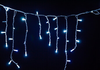 Colored Christmas garlands on a black background