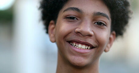 Mixed race young boy smiling at camera. Close-up portrait face