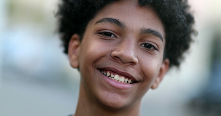 Mixed race young boy smiling at camera. Close-up portrait face