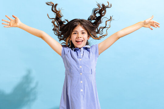 Portrait Of Winsome Little Girl,school Age Kid In Summer Dress Isolated Over Blue Background. Concept Of Children Emotions, Fashion, Beauty, School And Ad