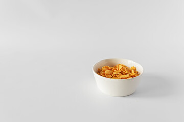 bowl of cornflakes on white background