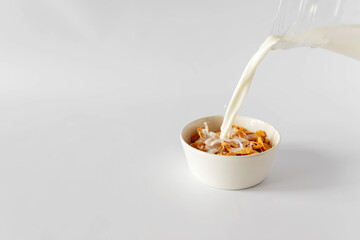 pouring milk into a bowl
