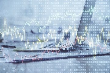 Stock market graph and table with computer background. Multi exposure. Concept of financial...