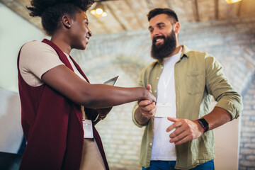 Businessman and businesswoman celebrating success by doing handshake in office