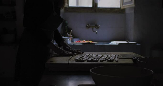 Making pasta. Cooking in a typical italian kitchen. Pici