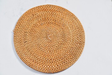 Fototapeta na wymiar Handmade round woven placemat.isolated on a white background.