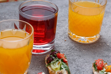 Summer drinks and toasts with fruits on a gray table. Healthy food, dietary snack, vegetarian snacks.