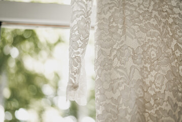 White wedding dress hanging close up shot