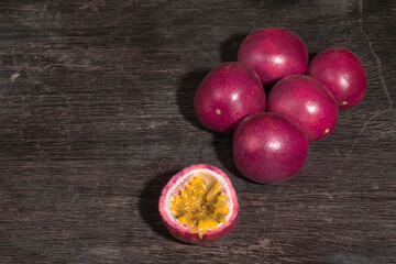 Vegetarian healthy food passion fruit on black wood table close up.