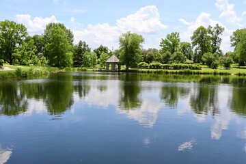 Fototapeta na wymiar The gazebo at a reflecting lake in the countryside.