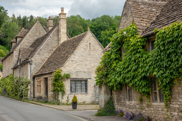 honey coloured Cotswold stone houses in Castle Combe Wiltshire England often named as the prettiest...