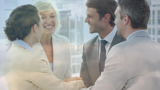 Animation of happy caucasian businesspeople shaking hands and talking over cityscape