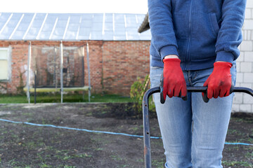 Cropped photo of a person flattening a piece of land