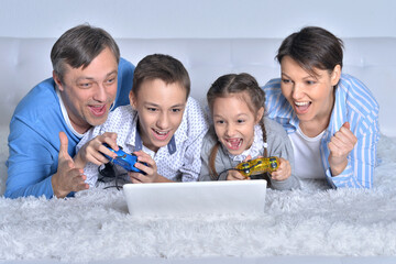 Smiling family looking at a laptop
