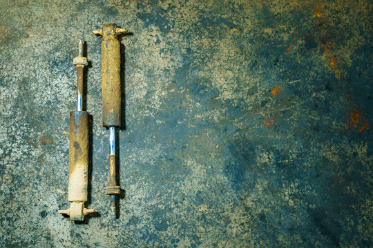 old shock absorber expire on dirty ground. suspension system truck