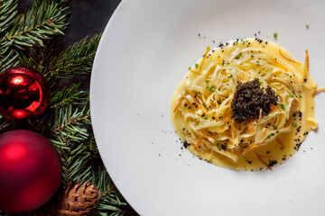 Spaghetti with sauce, sweet potatoes and black caviar
