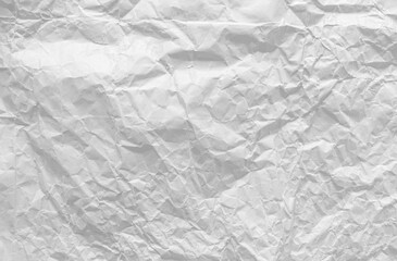 Top view of crumpled white paper for the background. Light and soft color background, large crumpled paper background texture for art design. The surface is not smooth but attractive.