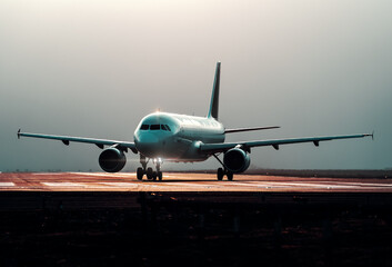 commercial airplane preparing for takeoff on the runway, front view