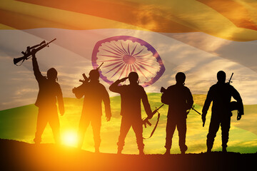 Silhouettes of soldiers on a background of India flag and the sunset or the sunrise. Greeting card...