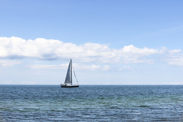 Fototapeta premium Beautiful seascape. Sailboat floats on the blue sea.