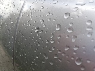 Raindrops on the car door. Small drops on metal