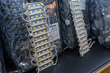 12 volt epoxy LED modules lights on display at an electronics store. An array of light emitting...