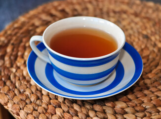 close up of cup of tea with blue stripes at home ,teatime and relax